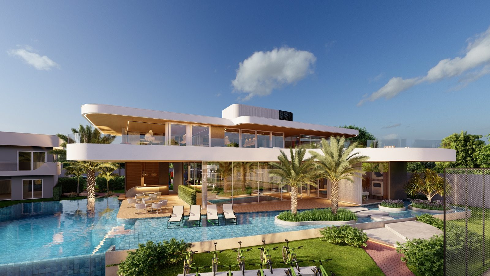 O clube visto de dia, com a piscina e o deck