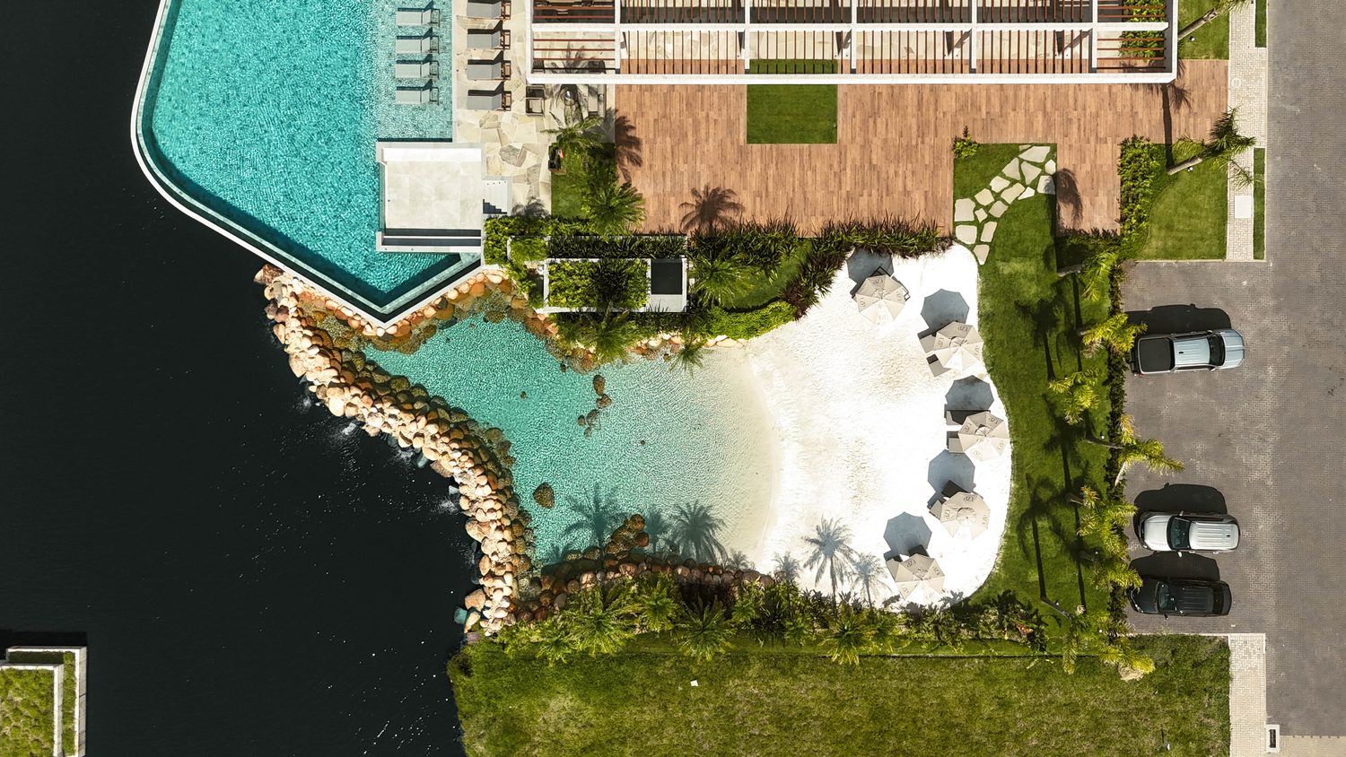 Prainha de areia às margens do lago, com piscina ao lado