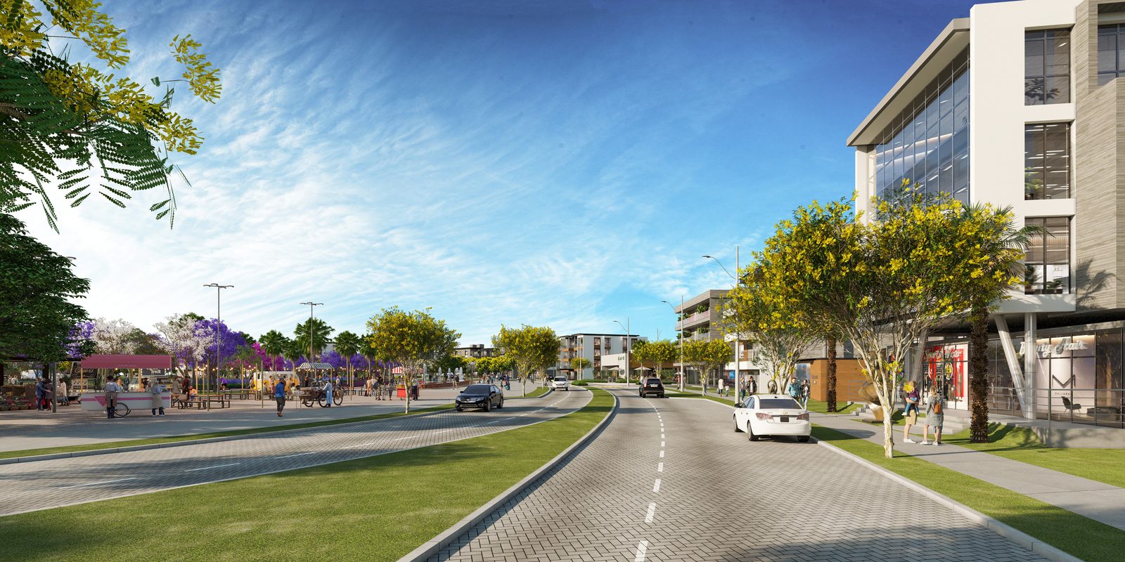 Avenida central com canteiro, ciclovia e prédios comerciais