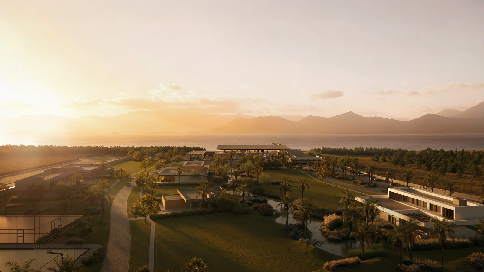 Vista do condomínio ao pôr do sol, com as casas, o clube e a lagoa ao fundo